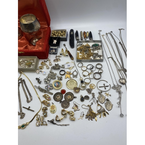 38 - A collection of silver, unmarked white metal and costume jewellery.