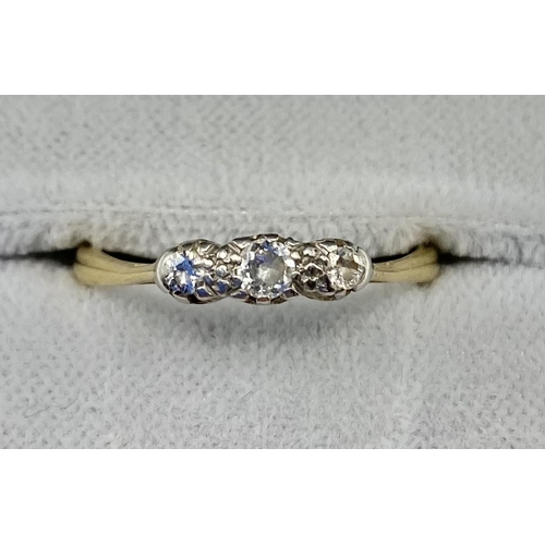 15 - An 18ct gold and diamond three stone ring. 2.26g. Size O.