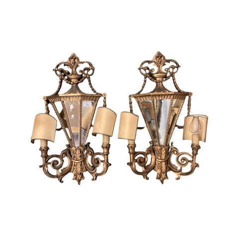 254 - A pair of late C19th wall sconces, with mirrored backs and carved wooden gilded all over design, app... 