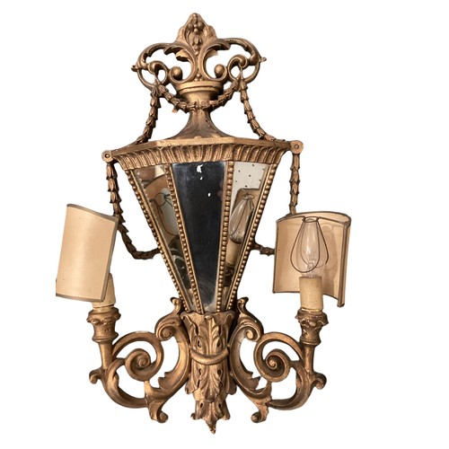 254 - A pair of late C19th wall sconces, with mirrored backs and carved wooden gilded all over design, app... 