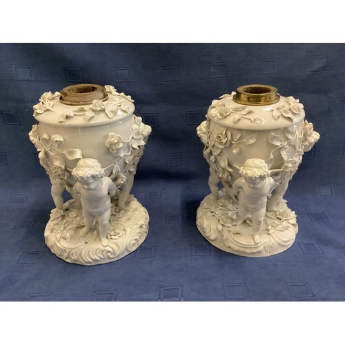 266 - A pair of Moore Bros, cherub stands, 24cm H, some losses