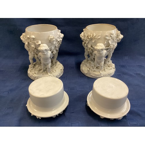 266 - A pair of Moore Bros, cherub stands, 24cm H, some losses