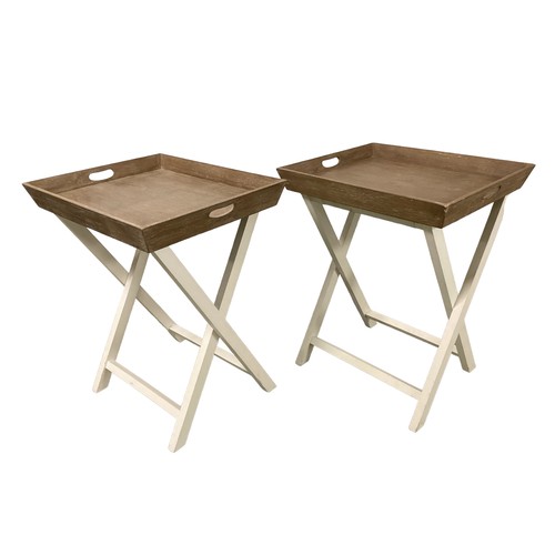 539 - A pair of modern Oka folding white tray tables on stands.