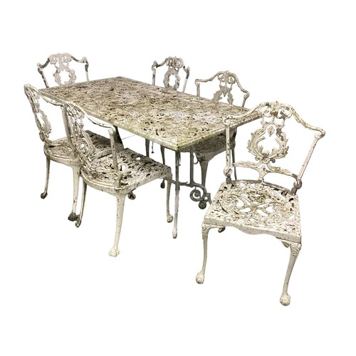 692 - A white metal set of  garden table and chairs, very weathered, 74 x 143cm W x 71cm high