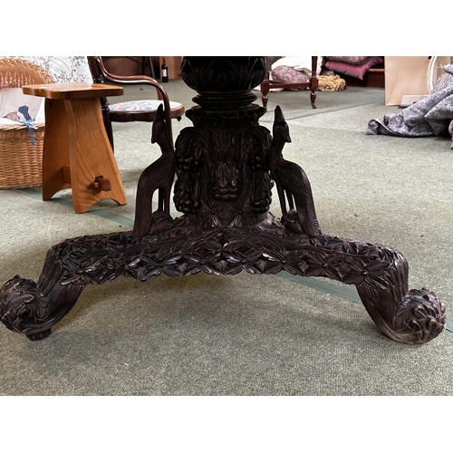 546 - A C19th carved Indian blackwood round pedestal table with pierced foliate frieze, the base carved wi... 