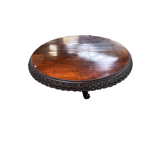 546 - A C19th carved Indian blackwood round pedestal table with pierced foliate frieze, the base carved wi... 