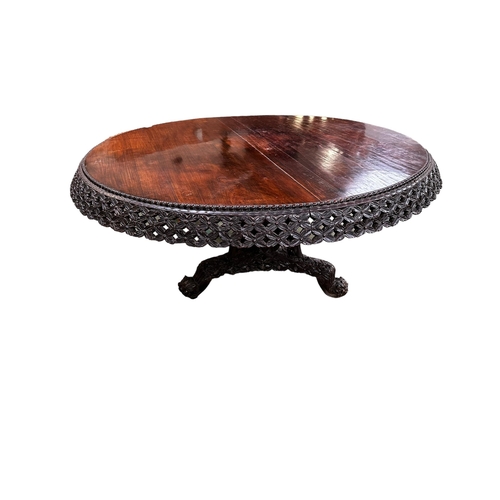 546 - A C19th carved Indian blackwood round pedestal table with pierced foliate frieze, the base carved wi... 