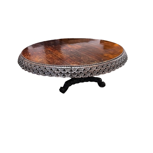 546 - A C19th carved Indian blackwood round pedestal table with pierced foliate frieze, the base carved wi... 