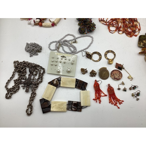 65 - A collection of costume and bead jewellery. A pair of amber drop ear rings. A jet style bead necklac... 