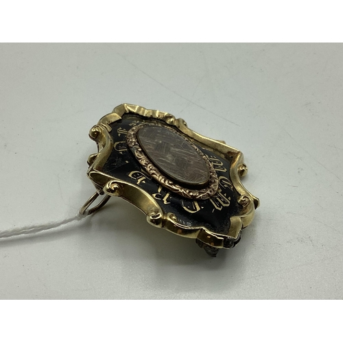 81 - An unmarked yellow metal and black enamel mourning Brooch with woven hair panel to centre, with gold... 