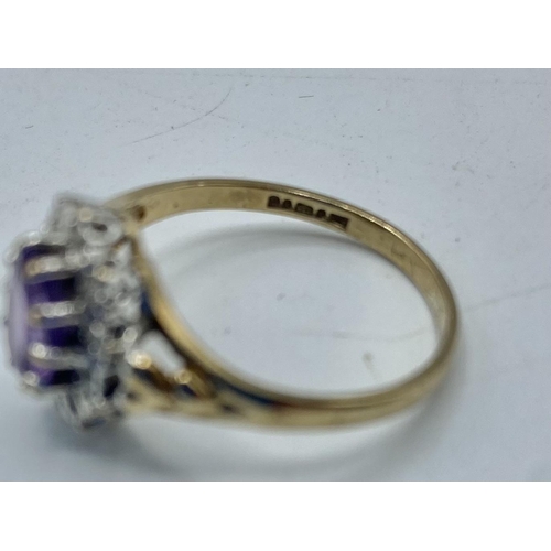 86 - A 9ct gold amethyst and diamond ring. Central oval free cut amethyst  with a surround of illusion se... 