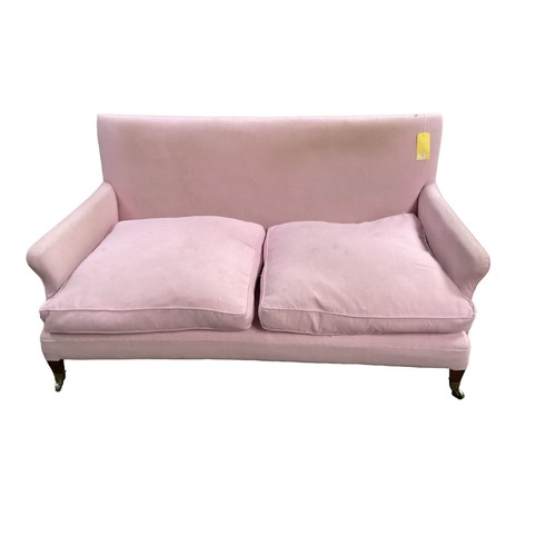 562 - A good two seater Howard style sofa upholstered in a pink fabric with mahogany tapered legs to brass... 