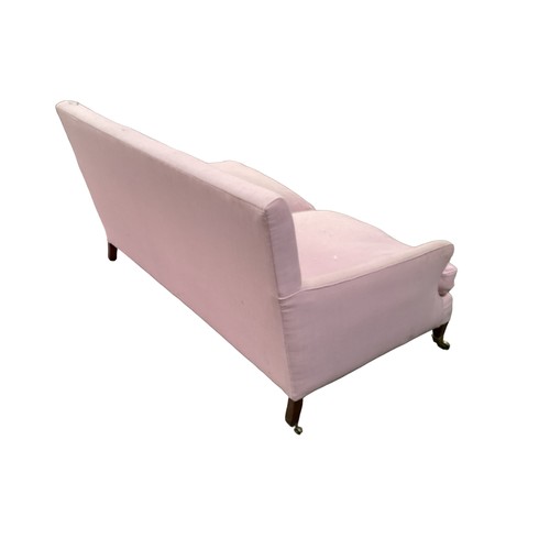 562 - A good two seater Howard style sofa upholstered in a pink fabric with mahogany tapered legs to brass... 