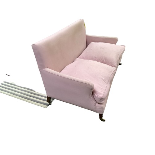 562 - A good two seater Howard style sofa upholstered in a pink fabric with mahogany tapered legs to brass... 