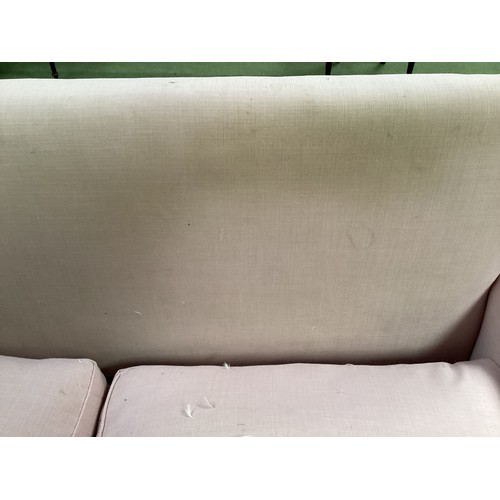 562 - A good two seater Howard style sofa upholstered in a pink fabric with mahogany tapered legs to brass... 