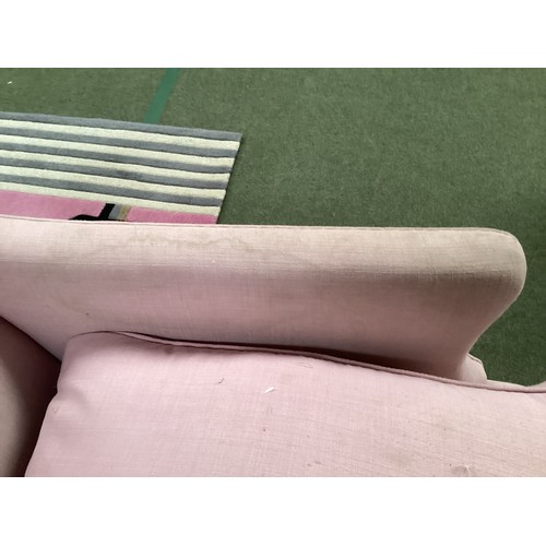 562 - A good two seater Howard style sofa upholstered in a pink fabric with mahogany tapered legs to brass... 