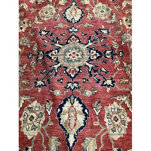 516 - A large good quality red ground rug, some wear and fraying to edge commensurate with age and use 436... 