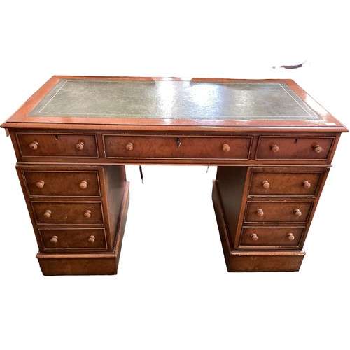 568 - A late Victorian honey coloured oak twin pedestal writing  desk with knob handles, and tooled green ... 