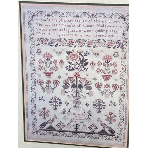 427 - A 19th century embroidery sampler. Elizabeth Wade aged 13. Dated 1824. In a glazed frame. 40cm x 30c... 