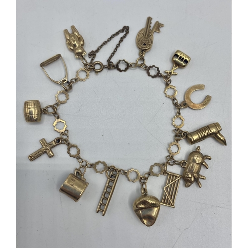 11 - A 9ct gold charm bracelet set with twelve  9ct gold and one unmarked yellow metal charm together wit... 