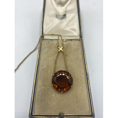 15 - An unmarked yellow metal and quartz  pendant necklace, Single circular free cut orange quartz approx... 