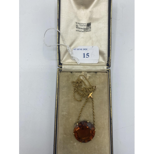 15 - An unmarked yellow metal and quartz  pendant necklace, Single circular free cut orange quartz approx... 