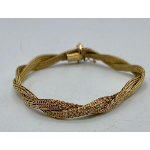 163 - An 18ct gold twisted flat fancy link bracelet. 20cm, 14.8g