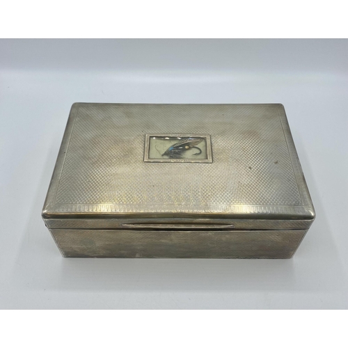 17 - A large sterling silver cedar lined  cigarette/Cigar box. Set with glass panel to top containing a f... 