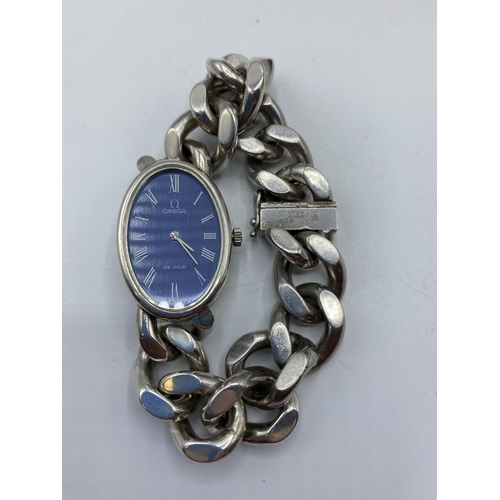 172 - An Omega DeVille Streling silver ladies watch. Oval blue face with Roman numeral markers. On Omega s... 
