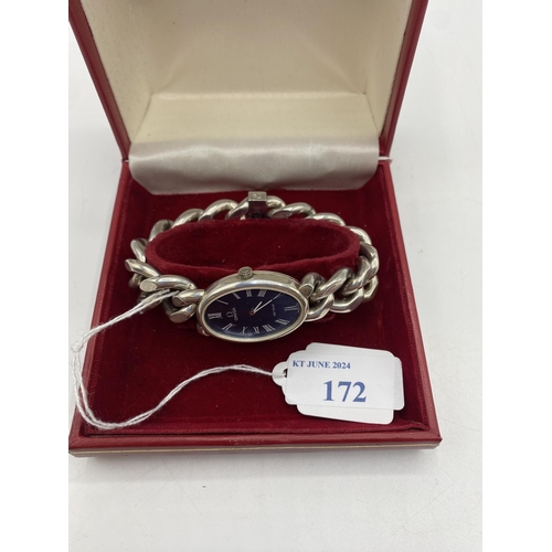 172 - An Omega DeVille Streling silver ladies watch. Oval blue face with Roman numeral markers. On Omega s... 