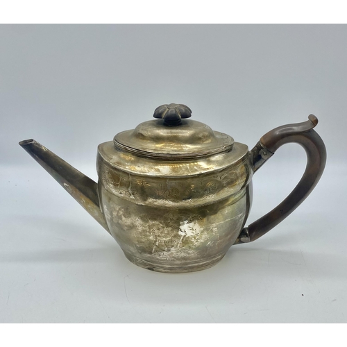 19 - A Georgian sterling silver tea pot with chased decoration by Solomon Hougham, London 1800. Gross wei... 