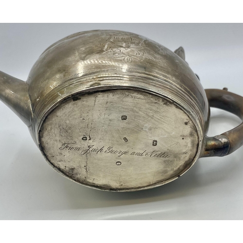 19 - A Georgian sterling silver tea pot with chased decoration by Solomon Hougham, London 1800. Gross wei... 