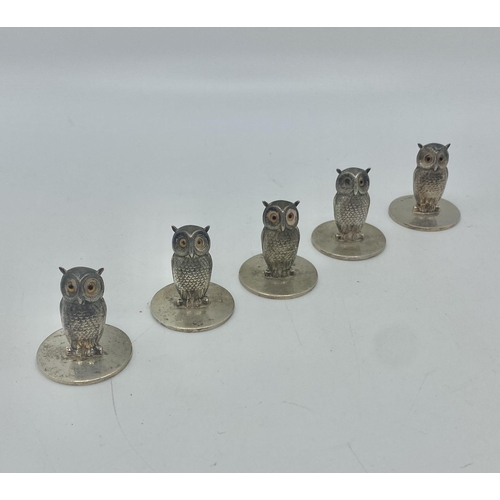 20 - A set of five sterling silver menu or name place holders in the form of owls with glass eyes by Samp... 