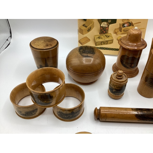 202 - A good collection of Mauchline ware items to include Napkin rings, pots boxes etc. Together with a b... 