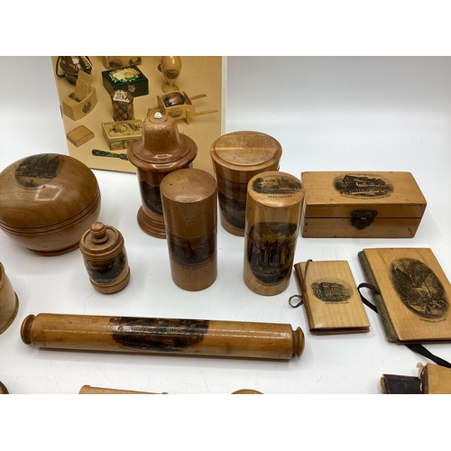 202 - A good collection of Mauchline ware items to include Napkin rings, pots boxes etc. Together with a b... 