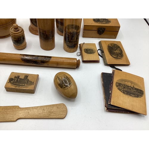 202 - A good collection of Mauchline ware items to include Napkin rings, pots boxes etc. Together with a b... 