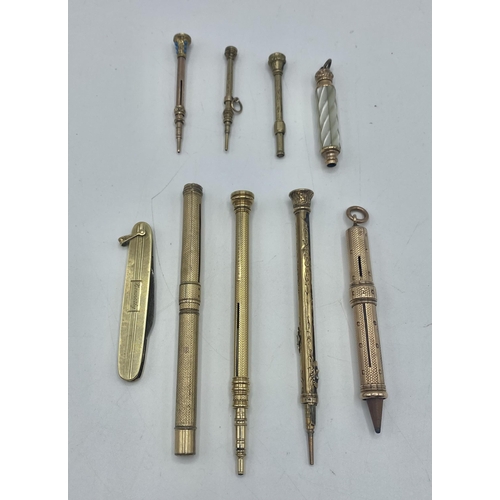 23 - A collection of unmarked yellow metal propelling pencils, holders and pens together with a 14ct gold... 