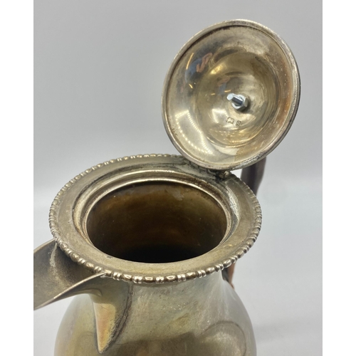 24 - A sterling silver hot water jug of bulbous form on circular stepped foot by Charles Packer and Co Lt... 