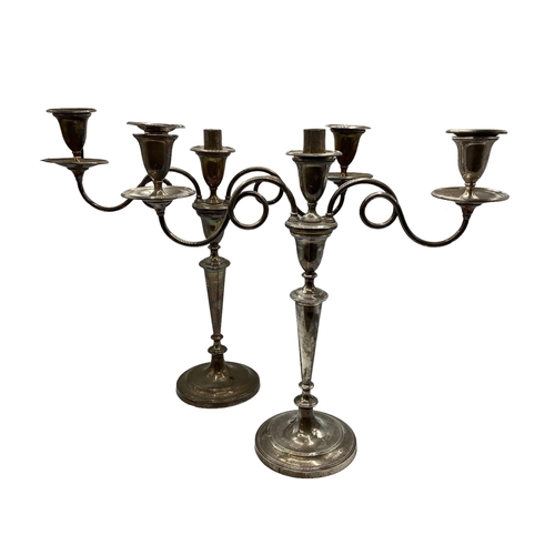 32 - A large pair of white metal candelabra. With bell hallmark in oval cartouche. 42cm x 46cm.