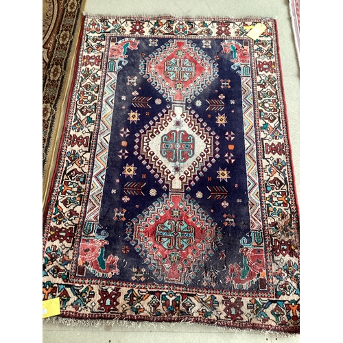 506 - Small blue rug with beige borders and three centred medallion 109 cm x 156 cm, some wear and damage ... 