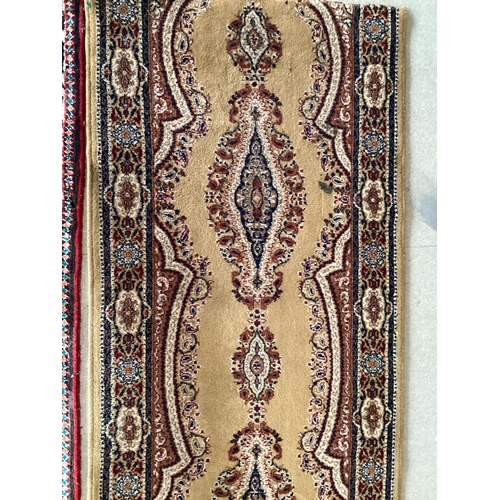 506 - Small blue rug with beige borders and three centred medallion 109 cm x 156 cm, some wear and damage ... 