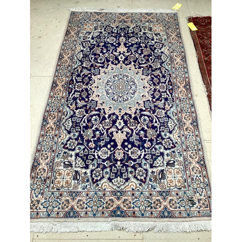 511 - A Persian wool rug,  blue and beige ground, with central star medallion, 114cm x 215cm, cleared from... 