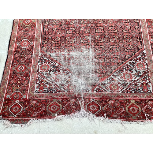 512 - Red rug in very worn condition and losses  140 cm x 200 cm sold as seen