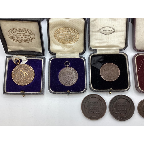 54 - A collection of bronze athletics medals 1920/30s to KW Hancock.