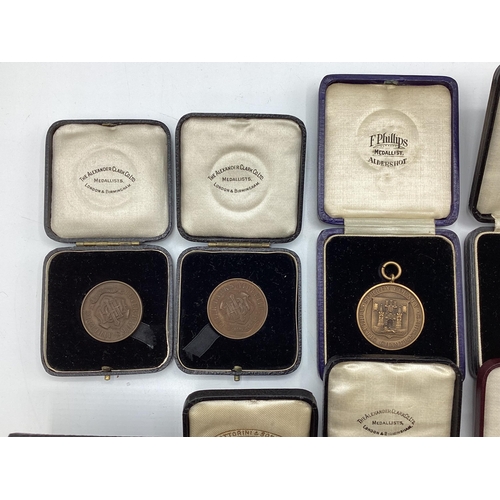 54 - A collection of bronze athletics medals 1920/30s to KW Hancock.