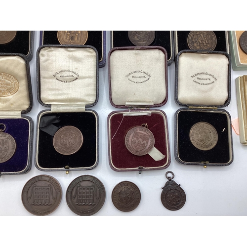 54 - A collection of bronze athletics medals 1920/30s to KW Hancock.