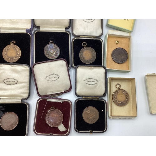 54 - A collection of bronze athletics medals 1920/30s to KW Hancock.