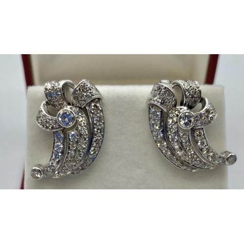 84 - A pair of unmarked white metal and diamond earrings Set throughout with brilliant and single cut dia... 