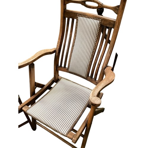 594 - Two Edwardian folding adjustable deck chairs, with studded striped black and white matching fabric