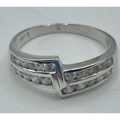 103 - An 18ct white gold and diamond half eternity ring. 3.6g. Size